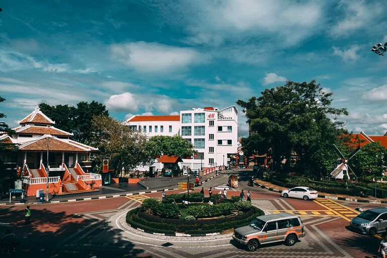 Road in Malaysia with buildings in the background - Cookiebot